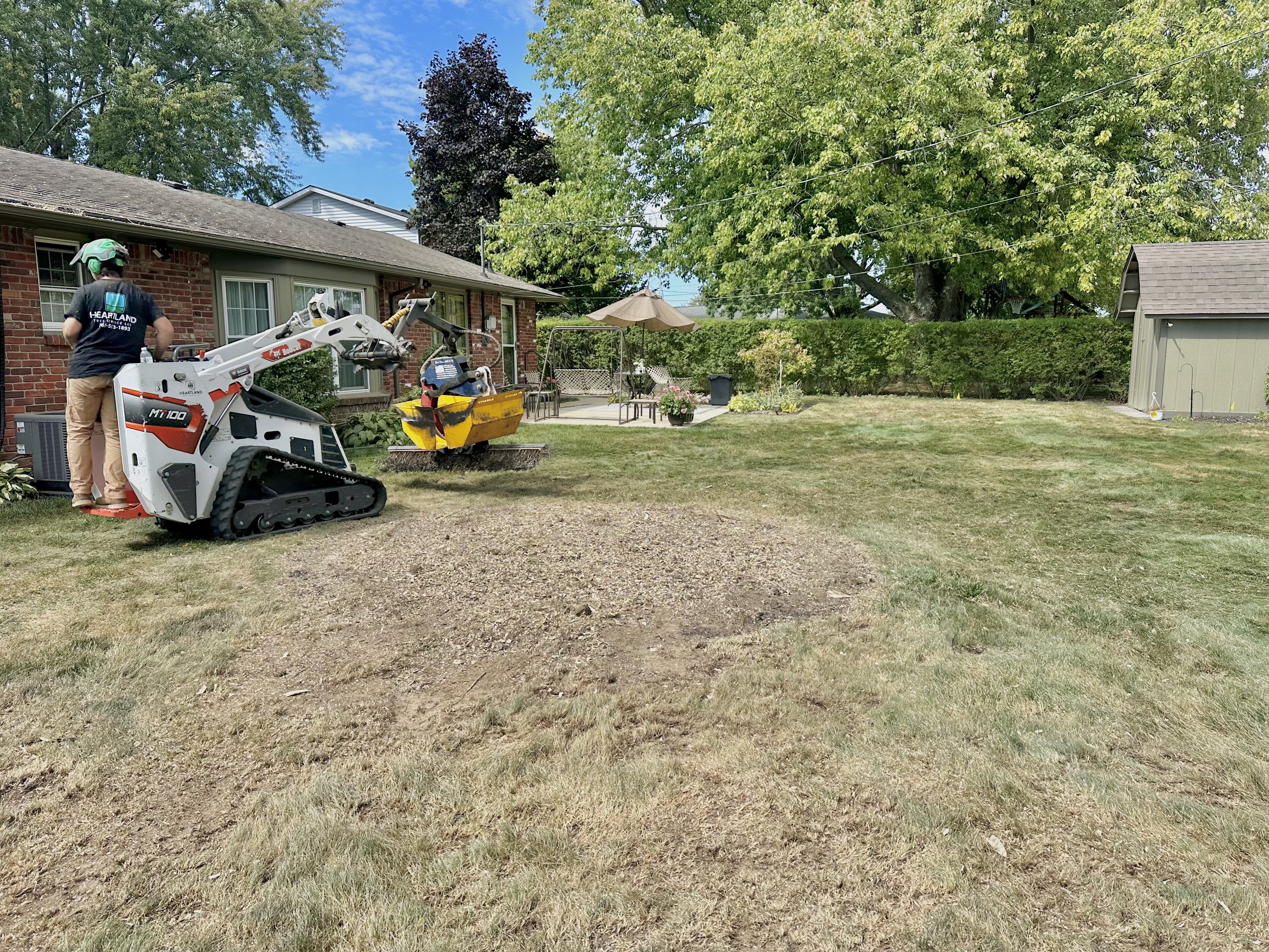 heartland tree services equipment and machinery parked at a yard